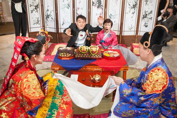 Pyebaek ceremony after wedding in Chinese culture, where dates and chestnuts are thrown in the bride's skirt by her in-laws to determine the number of kids she will have.