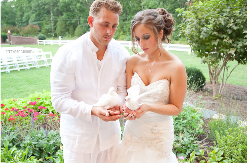 Filipino couples holding a pair of dove. 