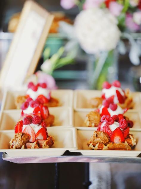 belgian waffles topped with vanilla ice cream, fresh berries, and almond butter