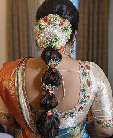 bubbled ponytail with floral embellishments and baby breaths