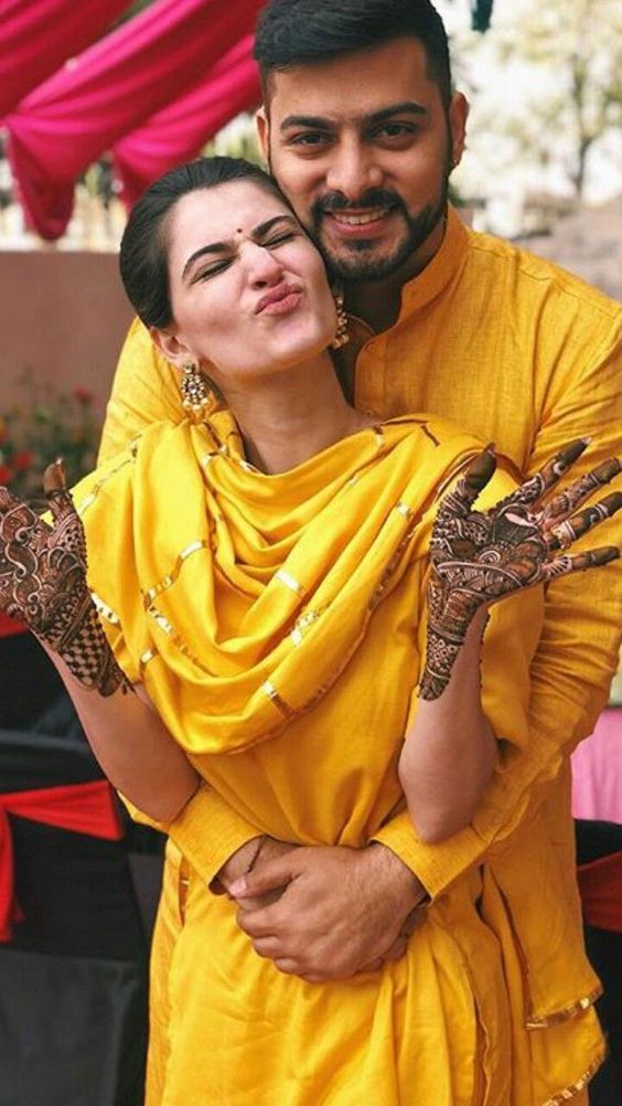 cute and wholesome mehndi poses of bride and groom