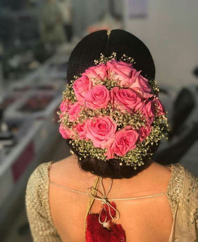 floral updo with baby breaths and pink roses hairstyles for saree