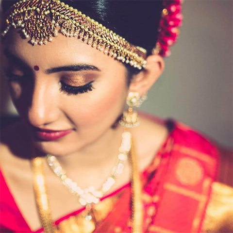 glittery eyes and red lips for south indian bridal makeup