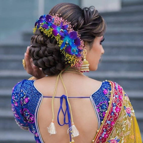 greek updo with flowers and crown braid hairstyles for saree