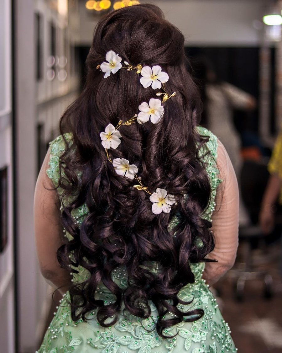 half tied hairdo with a swirl of flowers