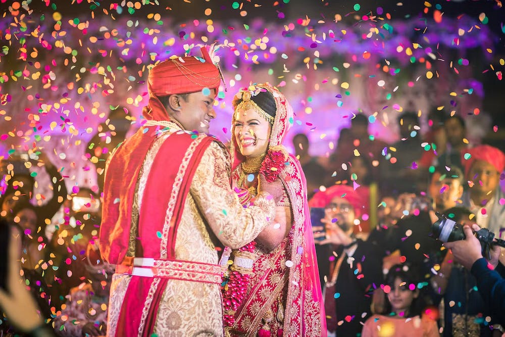 laugh under a confetti shower - wedding photoshoot