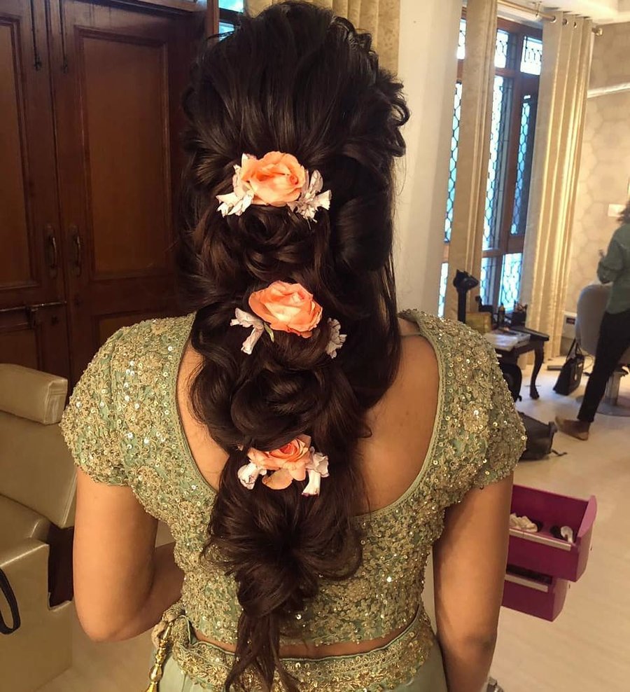 messy loose floral braid with orange flowers