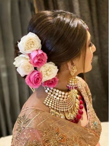 low bun with roses - lehenga hairstyles