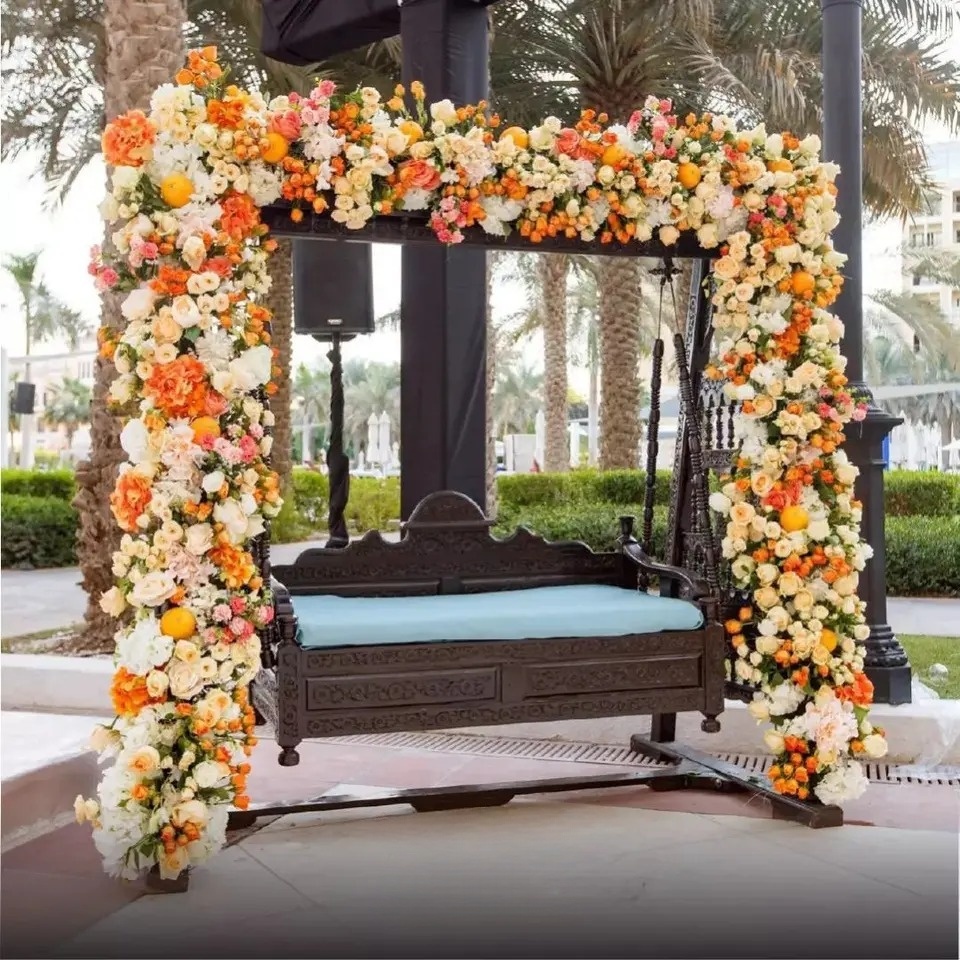 pastel flowers bordering the swing for background haldi ceremony decoration