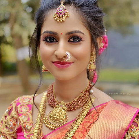 pink lips and bold eyes combination makeup look for south indian brides