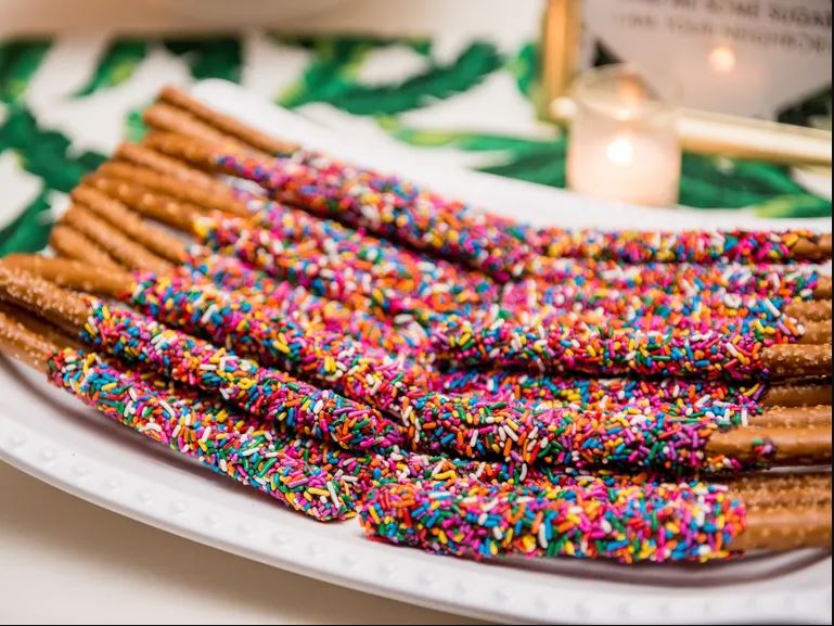 pretzels dipped in chocolate with rainbow sprinklers