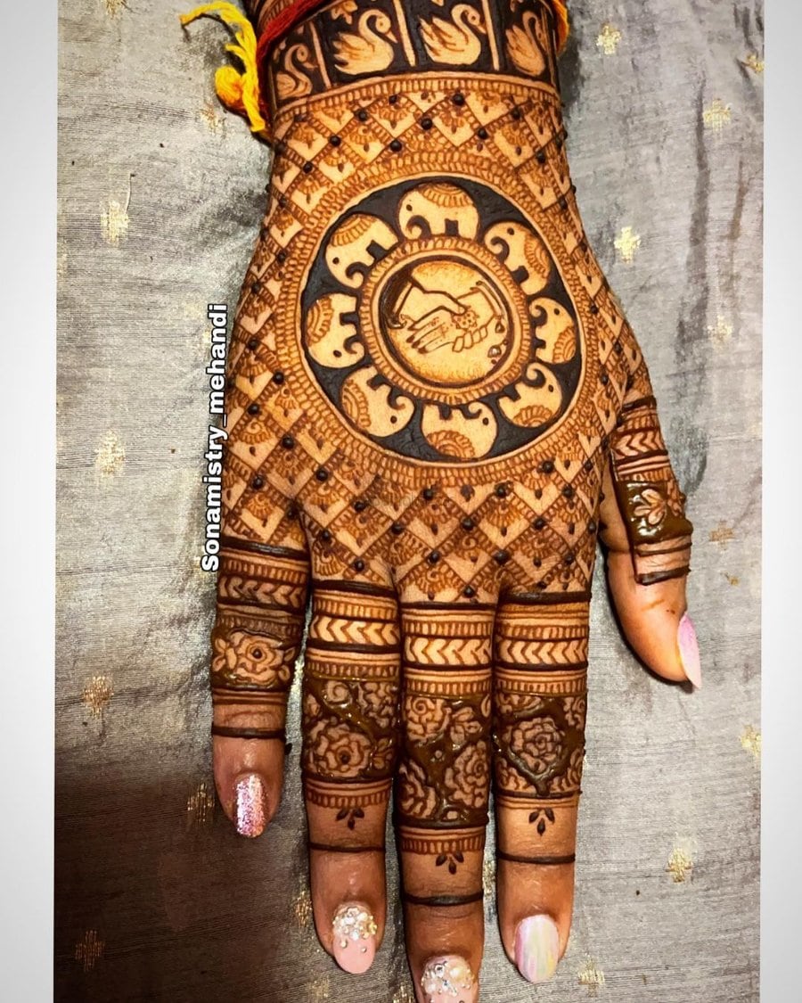 small elephant mehndi design with bride and groom handshake