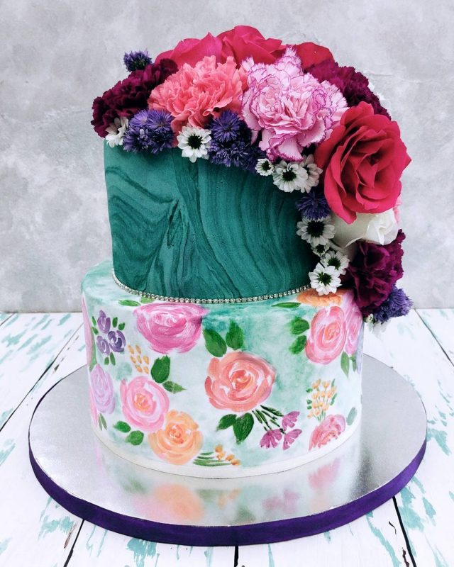 two tier elegant cake with carnations and roses